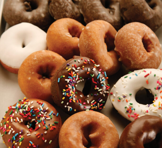 a large batch of assorted cake donuts
