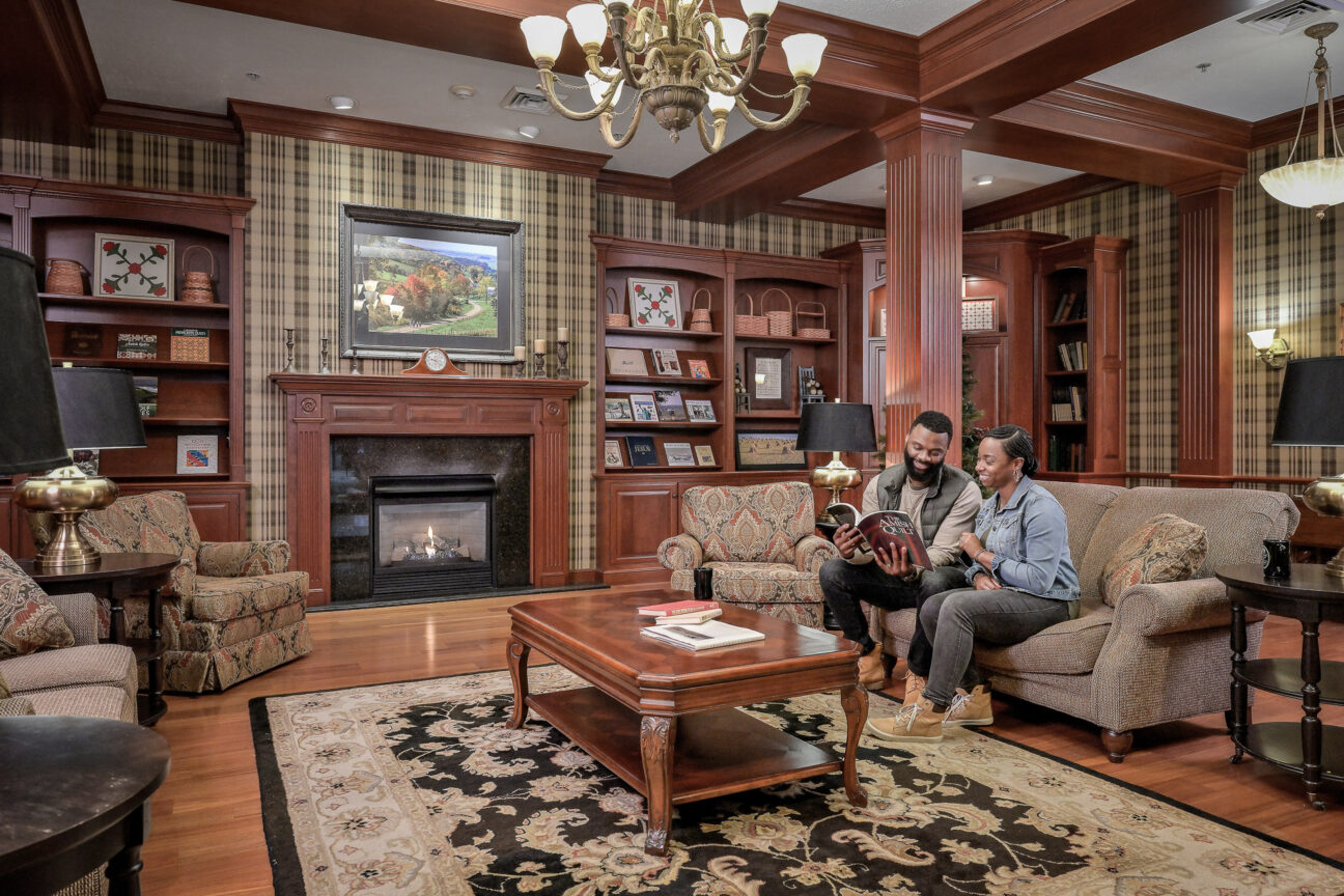 Couple reading on a couch in a large cozy room