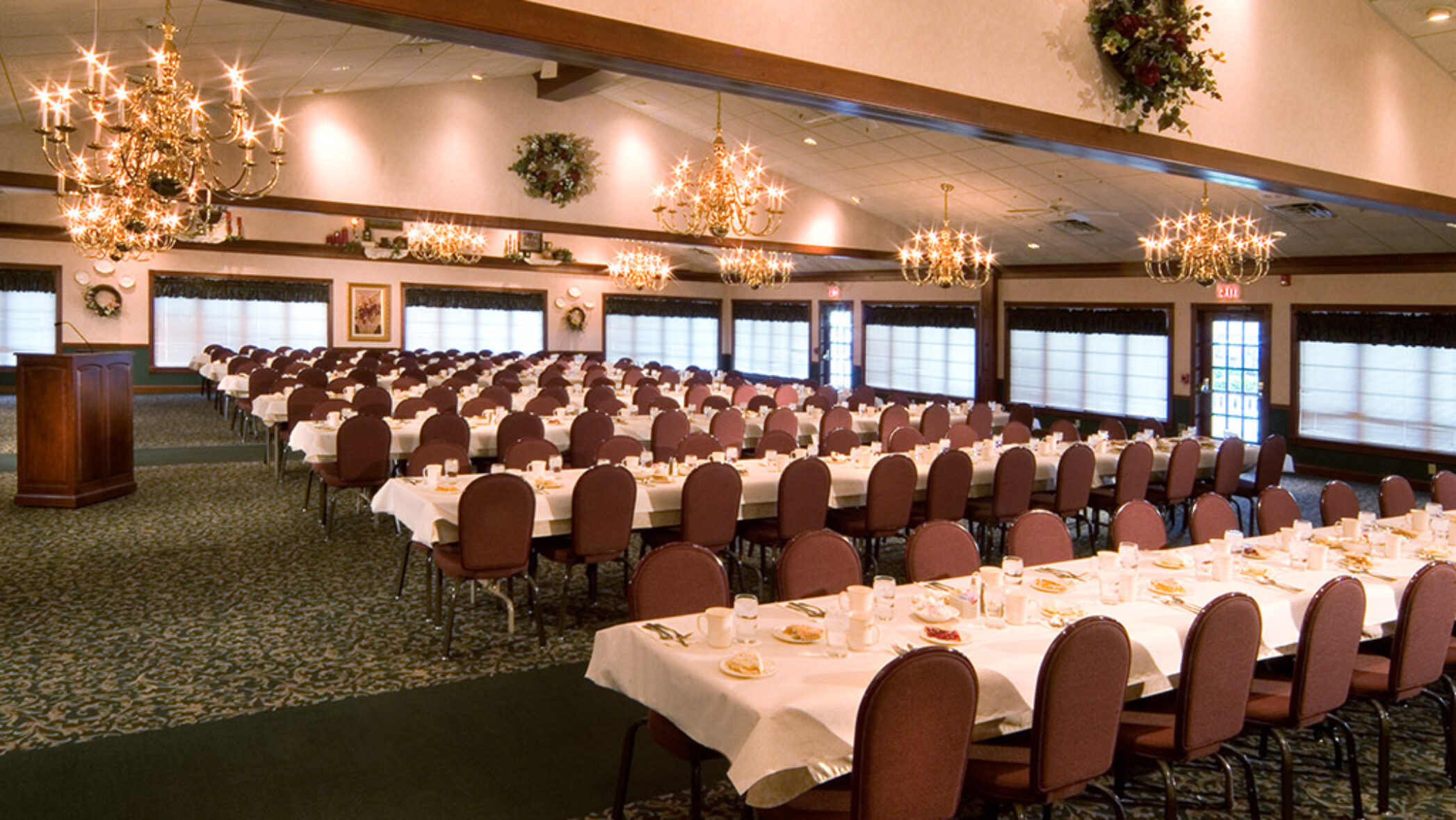 large banquet room with place-set tables and seating